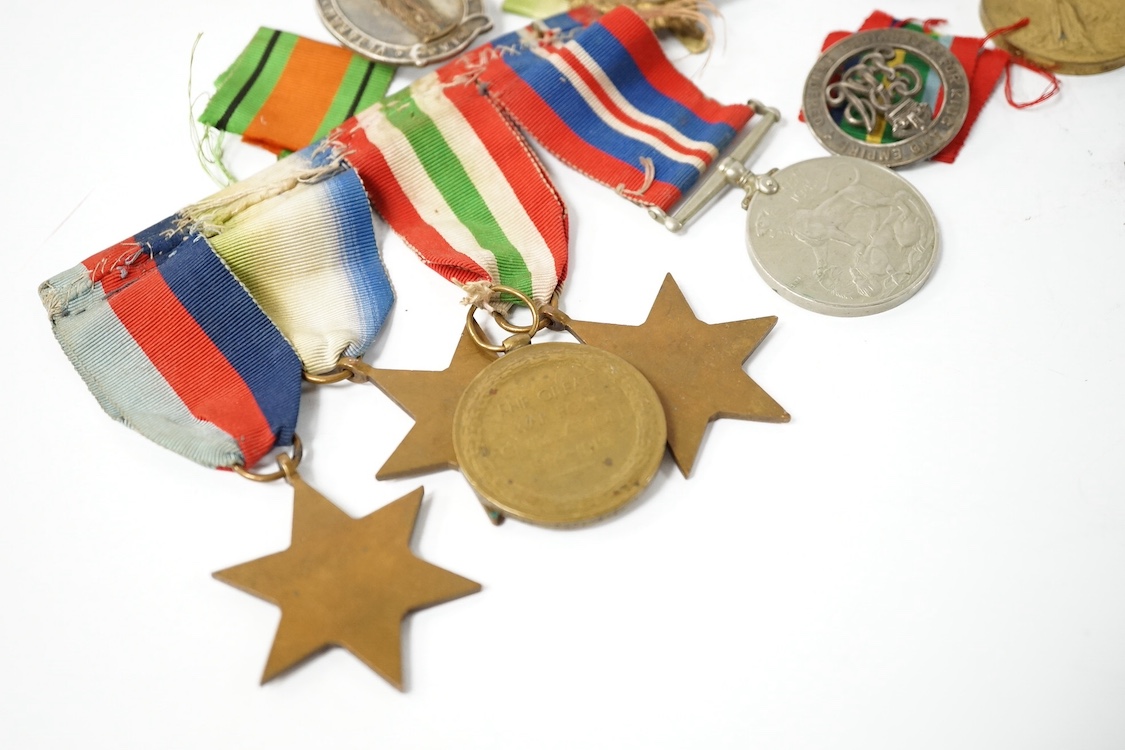 Nine military medals including; a First World War medal pair to T3-026887 DVR. C. Oldfield. A.S.C., a WWII group comprising; The Atlantic Star, The 1939-1945 Star, The Italy Star and The 1939-1945 Medal with a clasp for